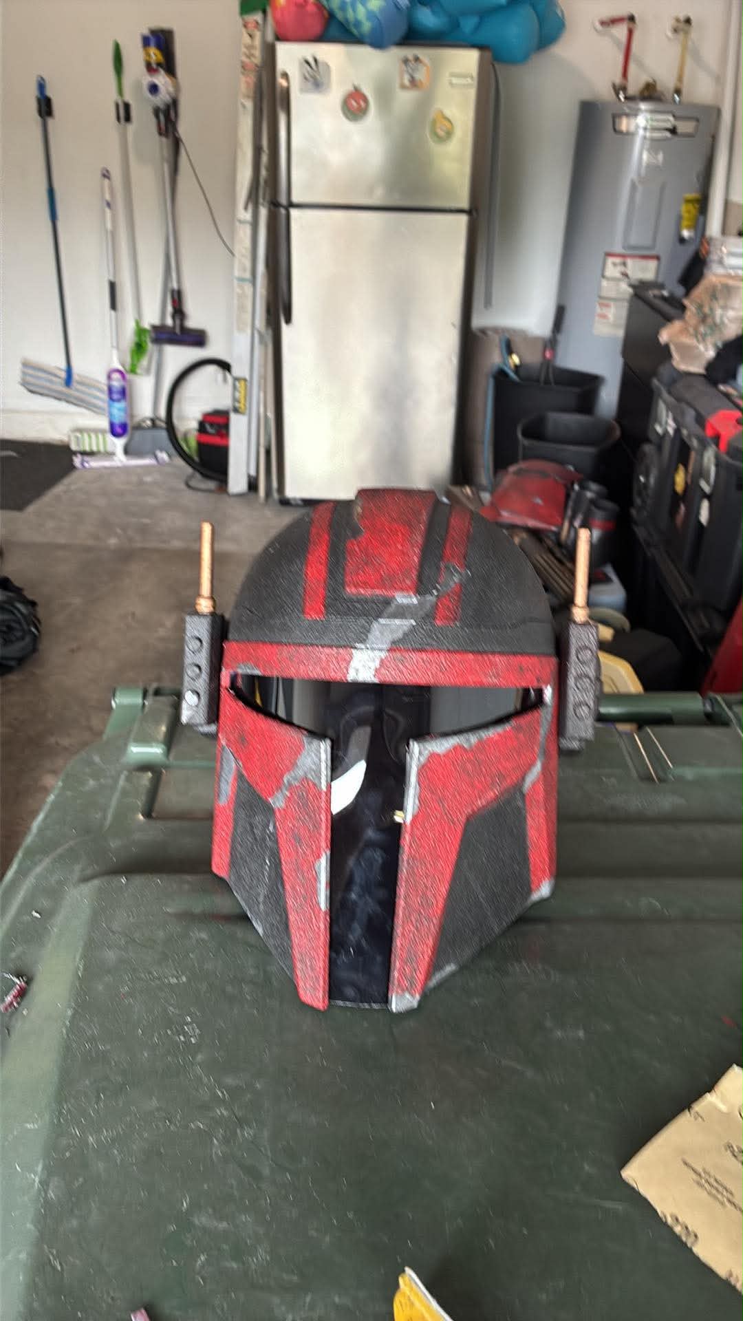 Weathered red-and-black helmet with a dark visor